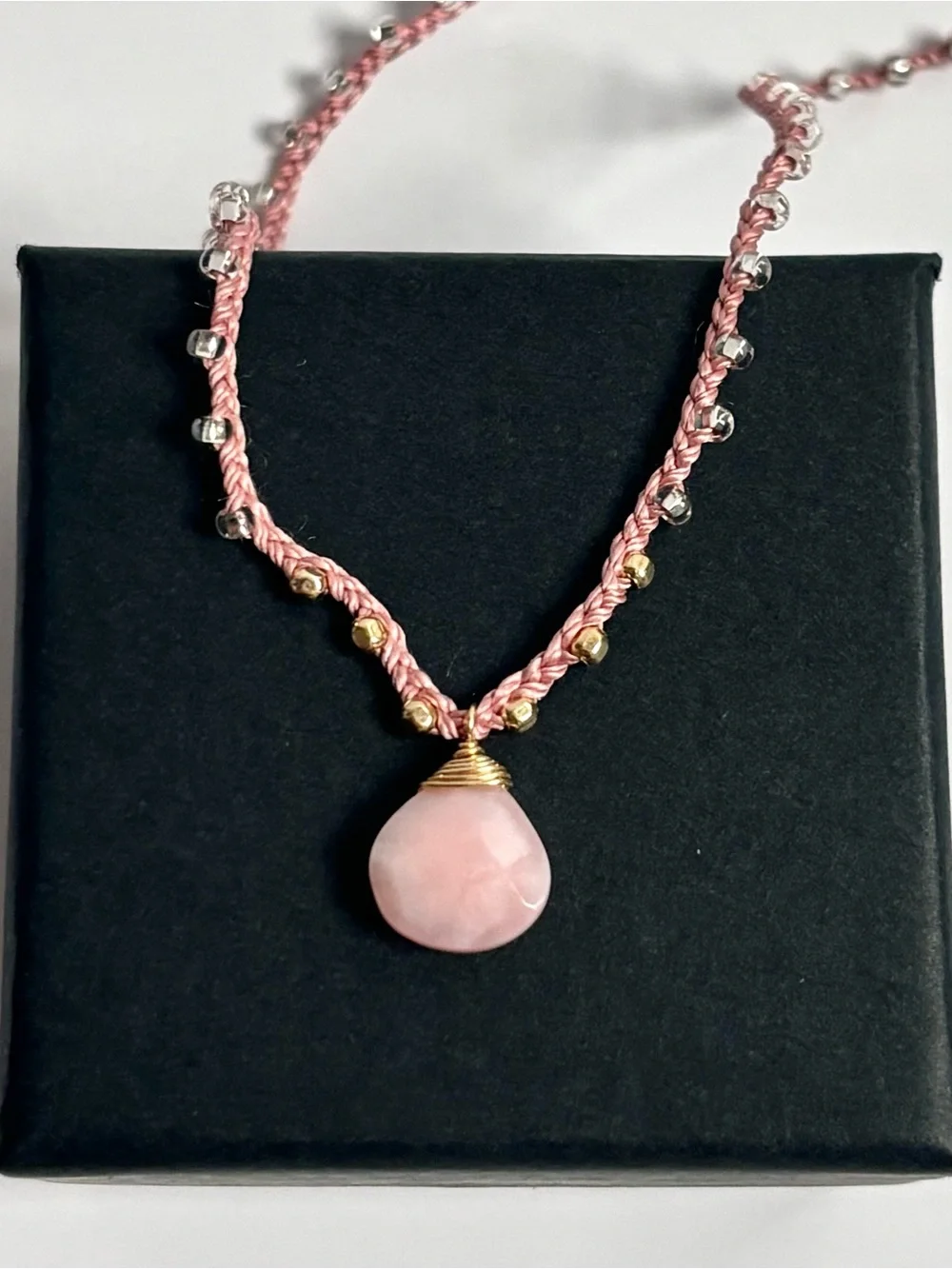 Pink silk thread necklace with a beautiful pink coral briolette stone